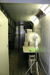 Crickets are bred and raised in the black containers visible along the wall. The insulated container is heated to a suitable temperature. Copyright Amphibian Research Centre. Photograph by Gerry Marantelli.